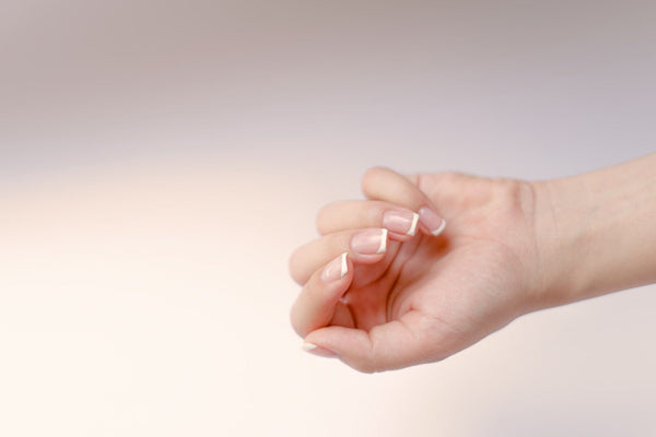 French Manicured Hand Against Blurred Background